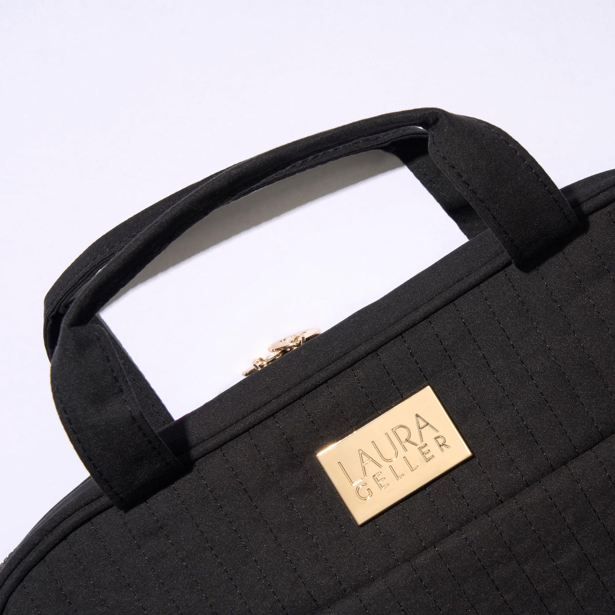 Laura Geller New York full-size makeup storage holds multiple items for extended trips.