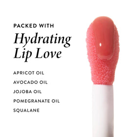 Laura Geller New York Lip Oil swiped across lips for instant hydration.