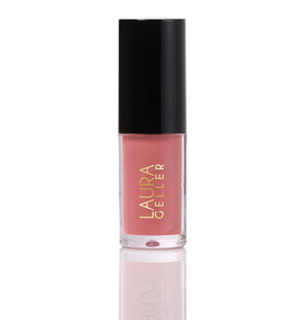 LAURA GELLER NEW YORK Treat-n-Go lip oil bottle closeup provides rich hydration and shine.