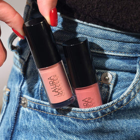 LAURA GELLER NEW YORK Treat-n-Go lip oil packaging with bag suggests on-the-go hydration.