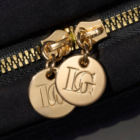Laura Geller New York water-resistant nylon keeps contents protected during travel.