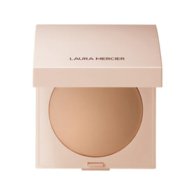 Laura Mercier Real Flawless powder compact close-up showing creamy texture and luminous finish.