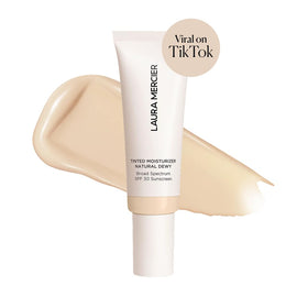 Laura Mercier Tinted Moisturizer bottle pump demonstrates easy, buildable coverage.