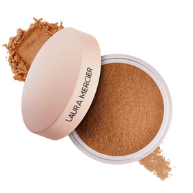 Laura Mercier Ultra-Blur Powder jar closeup showing a silky, pore-blurring finish.