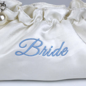 Lauusiusi blue bride embroidery detail—delicate touch of charm beside the gown.