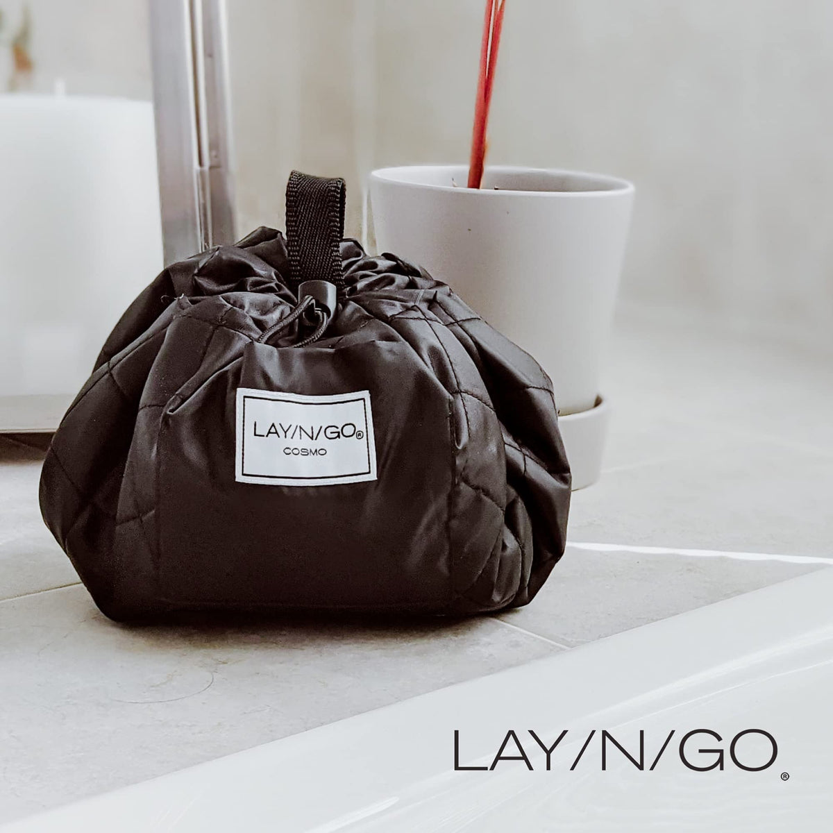 Lay-n-Go Cosmo bag with zip pocket keeps essentials organized during travel.