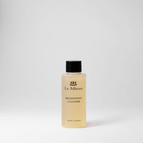 Applying Le Mieux Brightening Cleanser on face and neck for refreshment.