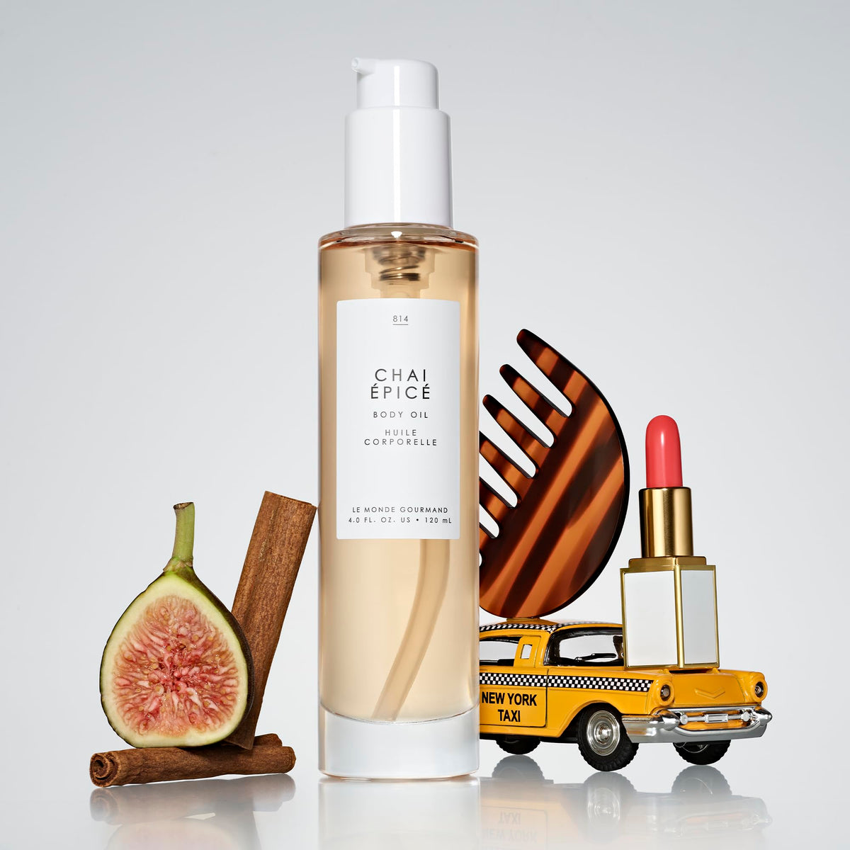 Le Monde Gourmand Spiced Chai body oil pump dispensing a silky feel.