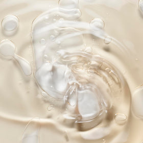 Le Monde Gourmand body oil applied to skin for a light, non-greasy glow.