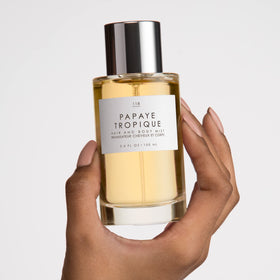 Hair application shot of Le Monde Gourmand Papaya Tropique adding a coconut aura.
