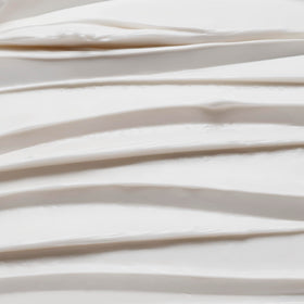 Le Monde Gourmand packaging beside coconut and vanilla pods evokes indulgence.
