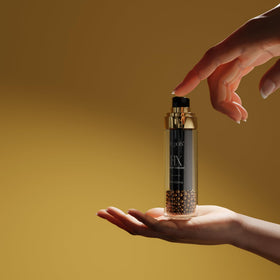 Rosehip oil bottle beside Le Pois FIX Night Cream for antioxidant hydration