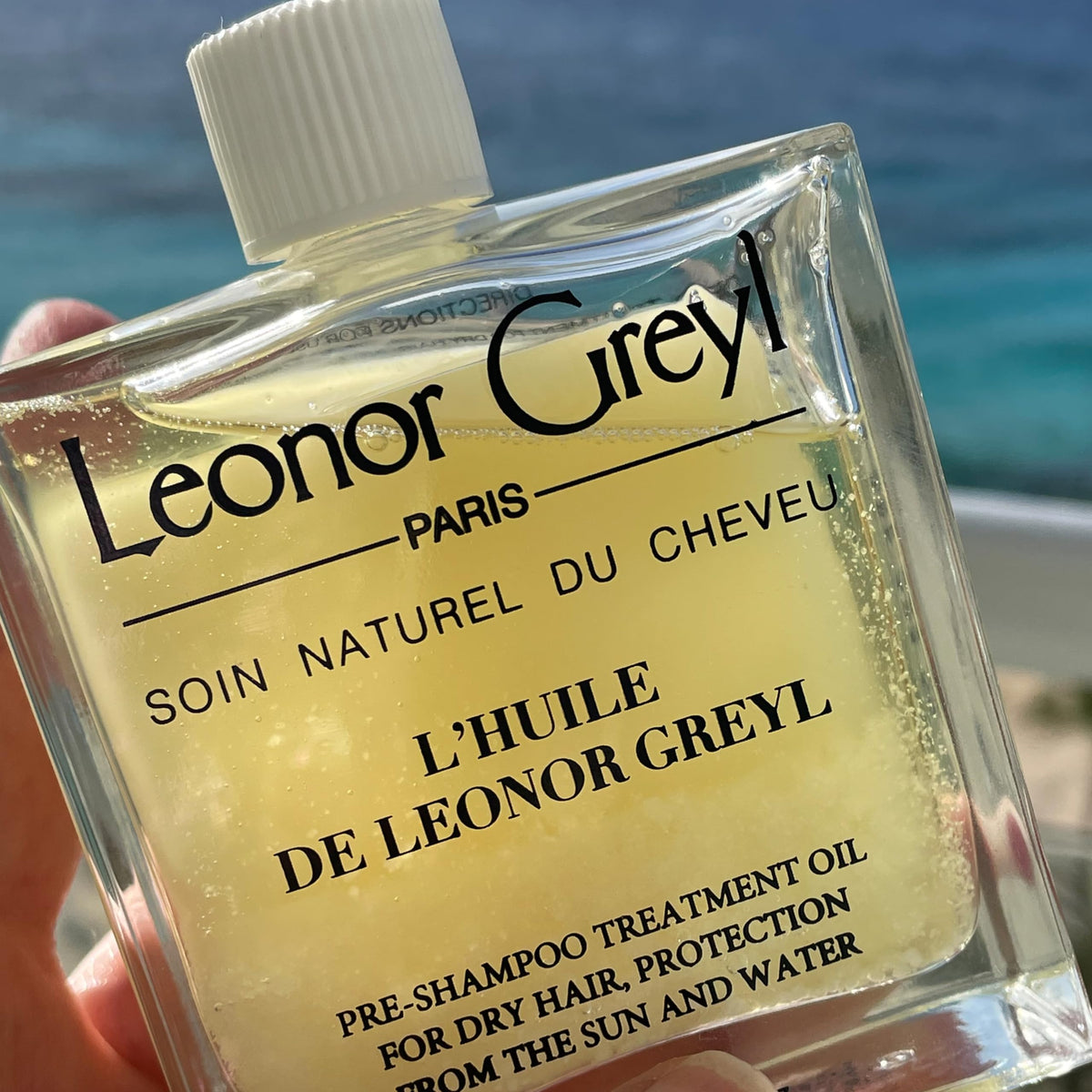 Close-up of oil sheen protecting hair at beach or pool.