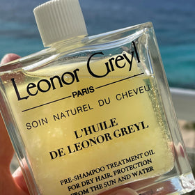 Close-up of oil sheen protecting hair at beach or pool.