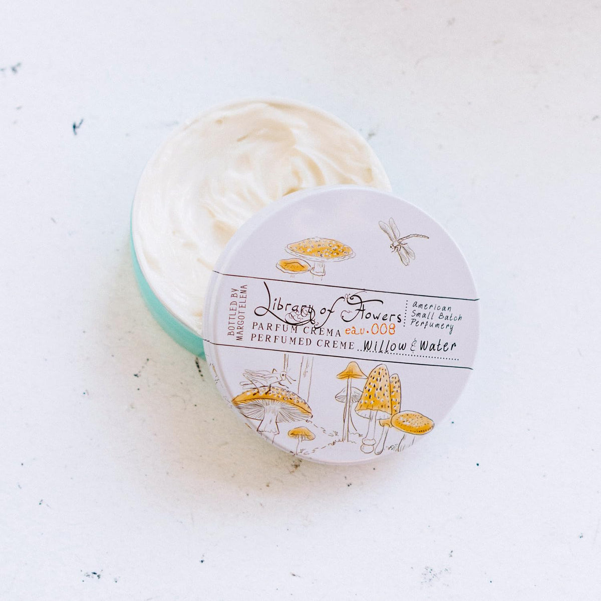 Library of Flowers Willow & Water Parfum Crema swirl application demonstrates fragrance release on skin.