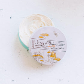Library of Flowers Willow & Water Parfum Crema swirl application demonstrates fragrance release on skin.