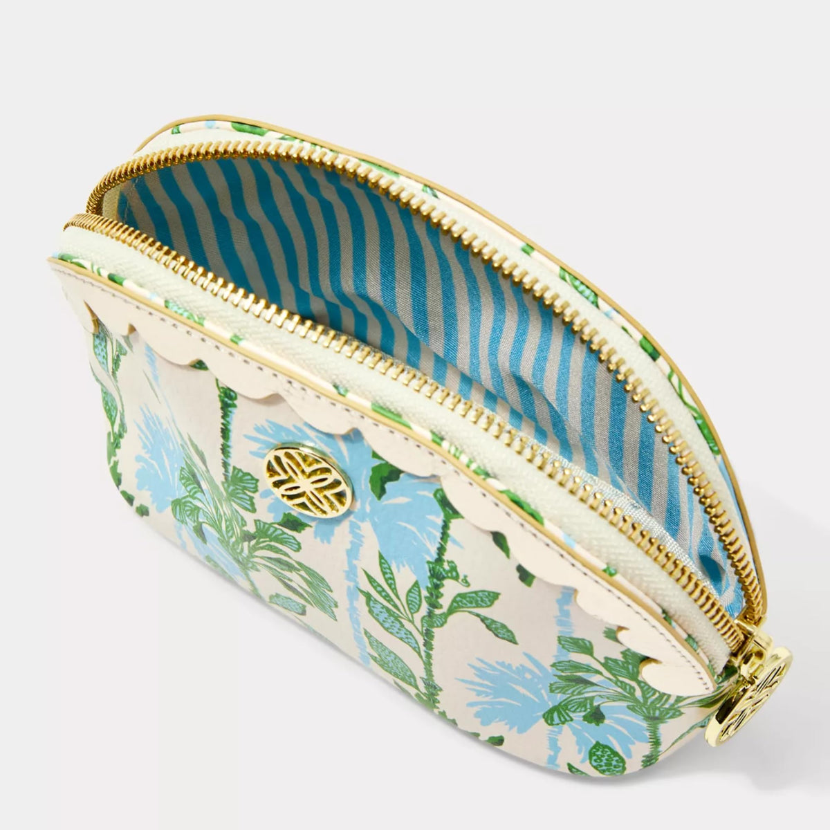 Gold logo plaque detail on Lilly Pulitzer vegan leather pouch highlights signature branding.