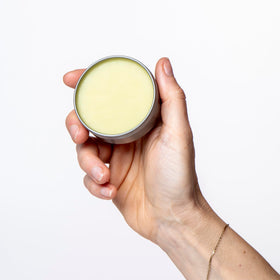 Hand-Aid balm on elbow for targeted moisturization