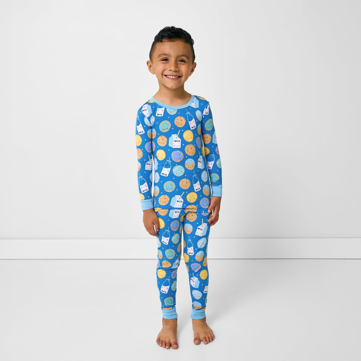 A child snuggling in bed while wearing Little Sleepies pajamas for a calm nighttime routine.