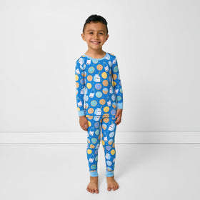 A child snuggling in bed while wearing Little Sleepies pajamas for a calm nighttime routine.