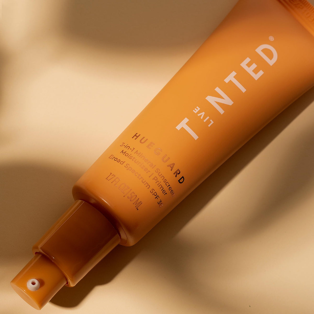 Hueguard reef-safe, vegan, fragrance-free formula label visible.