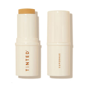 Live Tinted Superhue Stick applied to face for radiant, even tone.