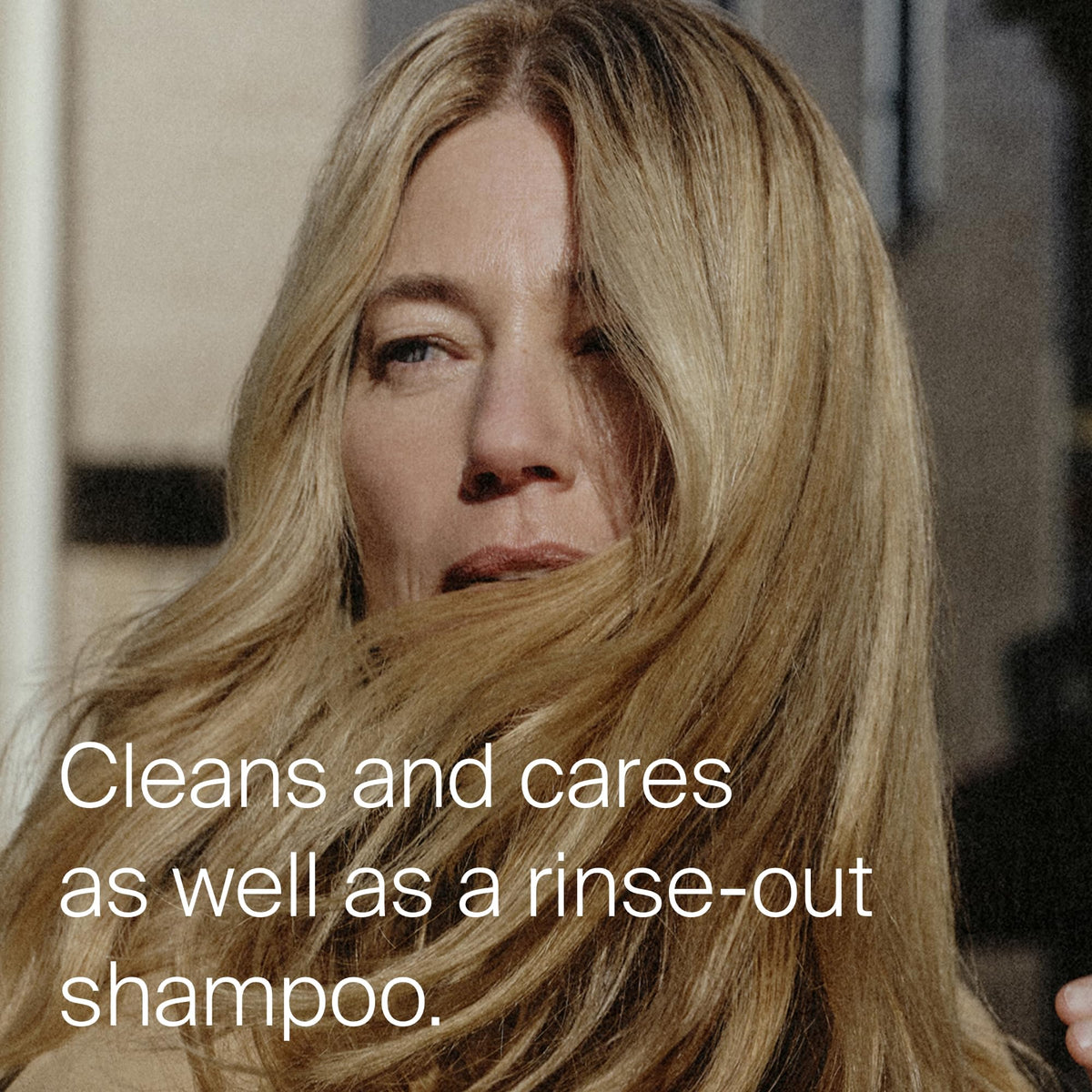 Living Proof Dry Shampoo being sprayed at roots to control oil