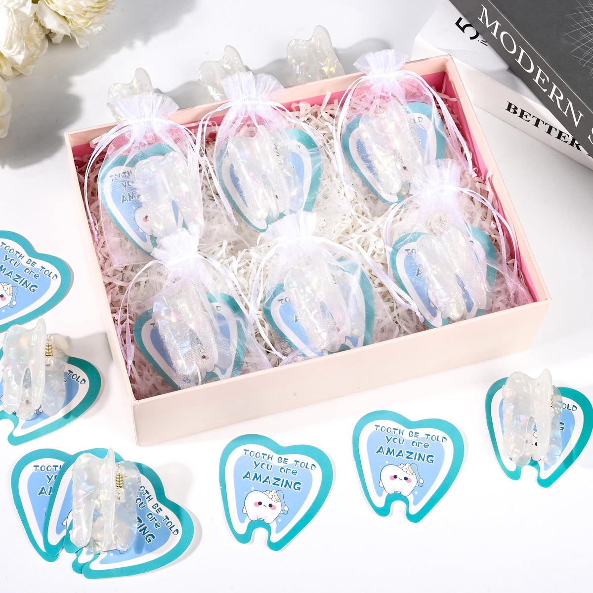 LiYiQ dental tooth claw clips arranged with organza bags and cards.