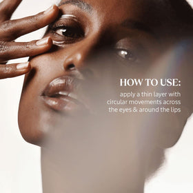 Applying Divine Eye Cream around the eye for smoothing and puffiness support.