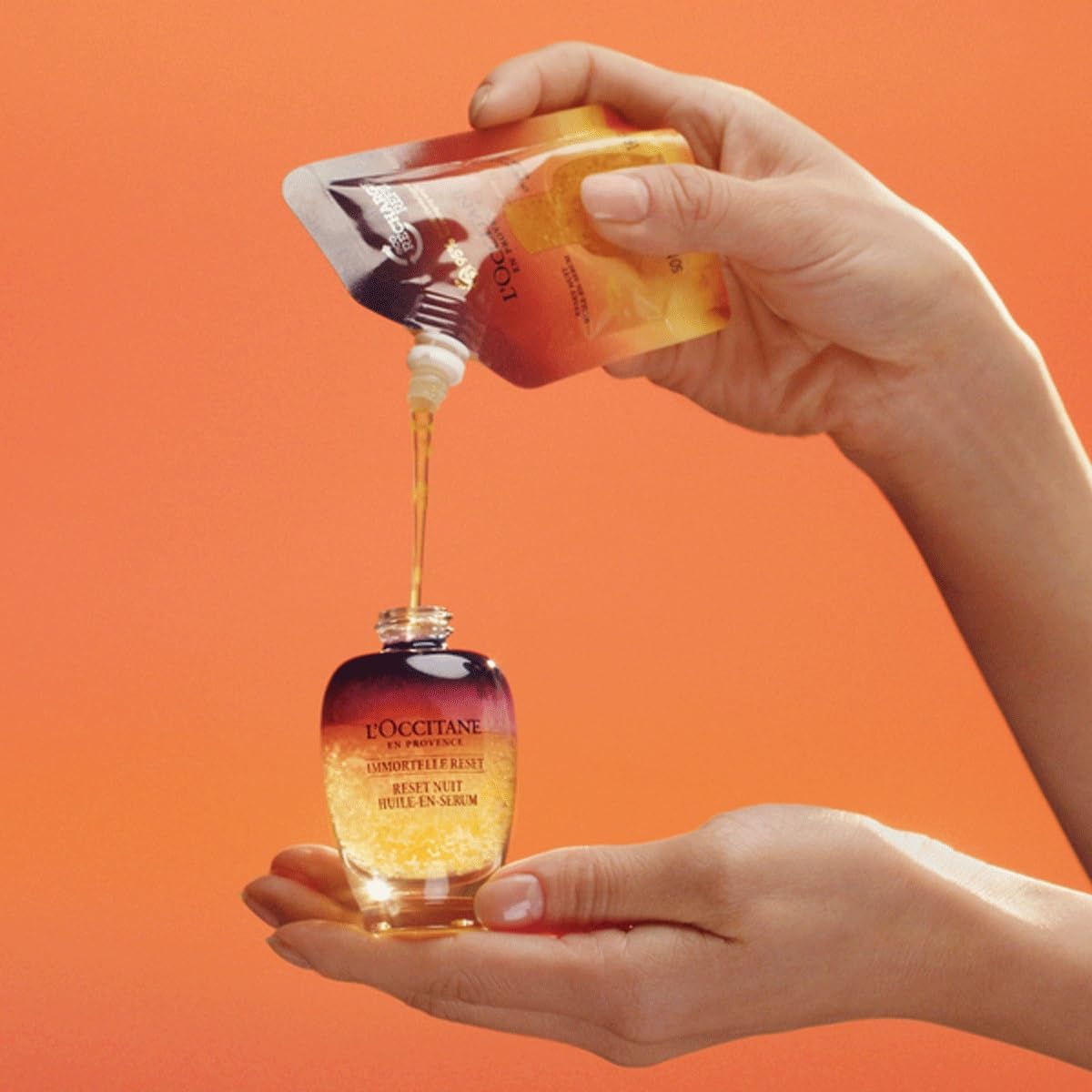 L'Occitane Immortelle Overnight Reset oil-serum pump-action demonstrates convenient use.