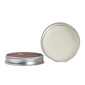Hands apply Lockhart's Goon Grease, shaping hair for a sleek look.