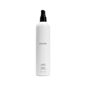 LolaVie Glossing Detangler bottle on bathroom shelf for silky detangling