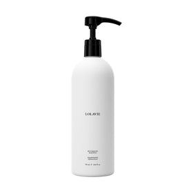 LolaVie Restorative Shampoo bottle close-up highlighting color-safe formula.