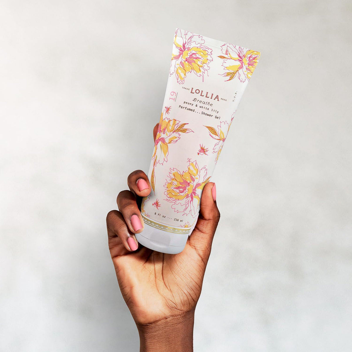 Hands applying LOLLIA Breathe Shower Gel to skin for refreshing cleanse.