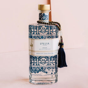 LOLLIA Dream Bubble Bath being poured forms rich, calming bubbles for a soothing soak.