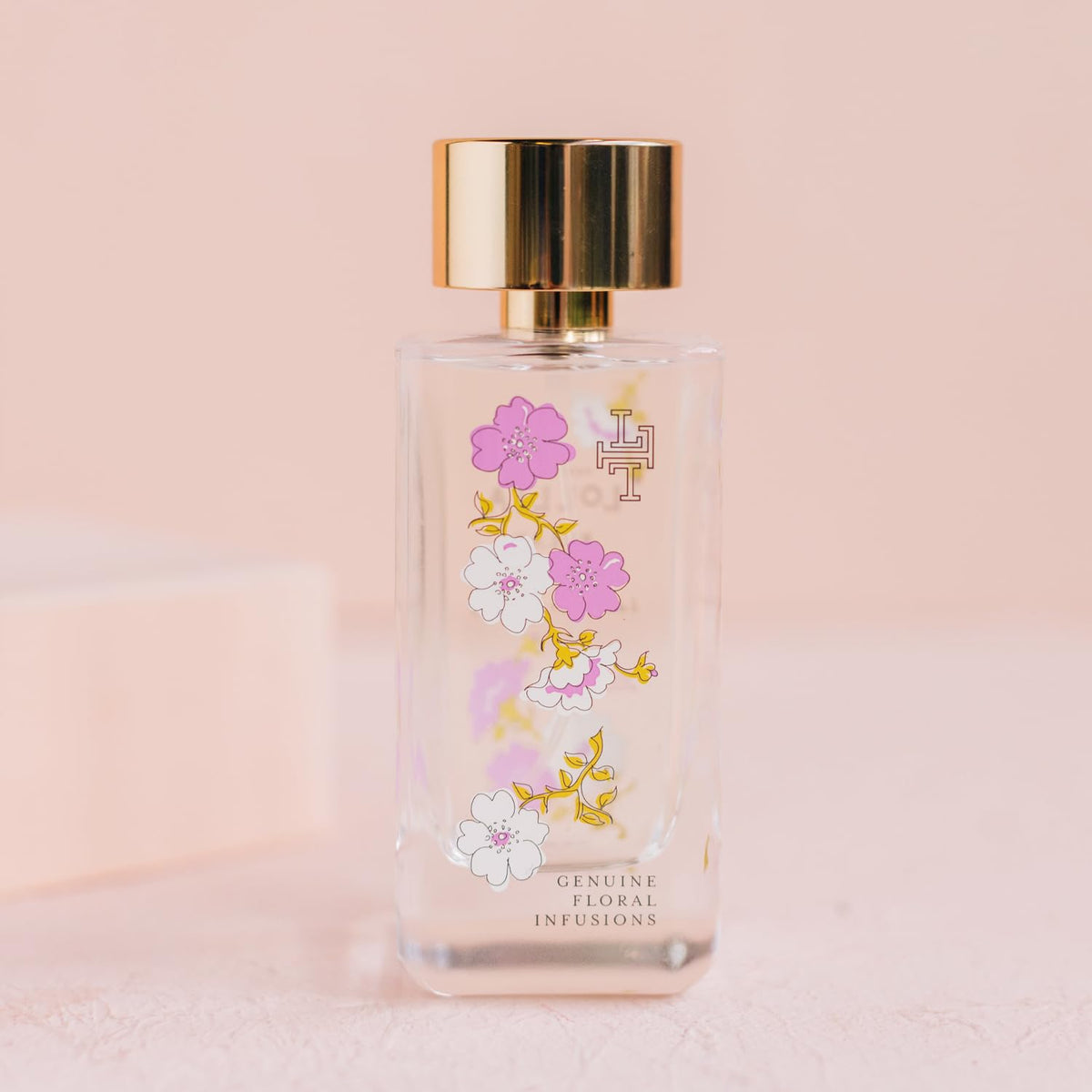 LOLLIA Relax spray-bottle application captured mid-spray for pulse points.