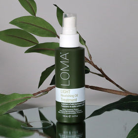 LOMA Nourishing Oil Treatment Light packaging shown as compact, travel-friendly bottle