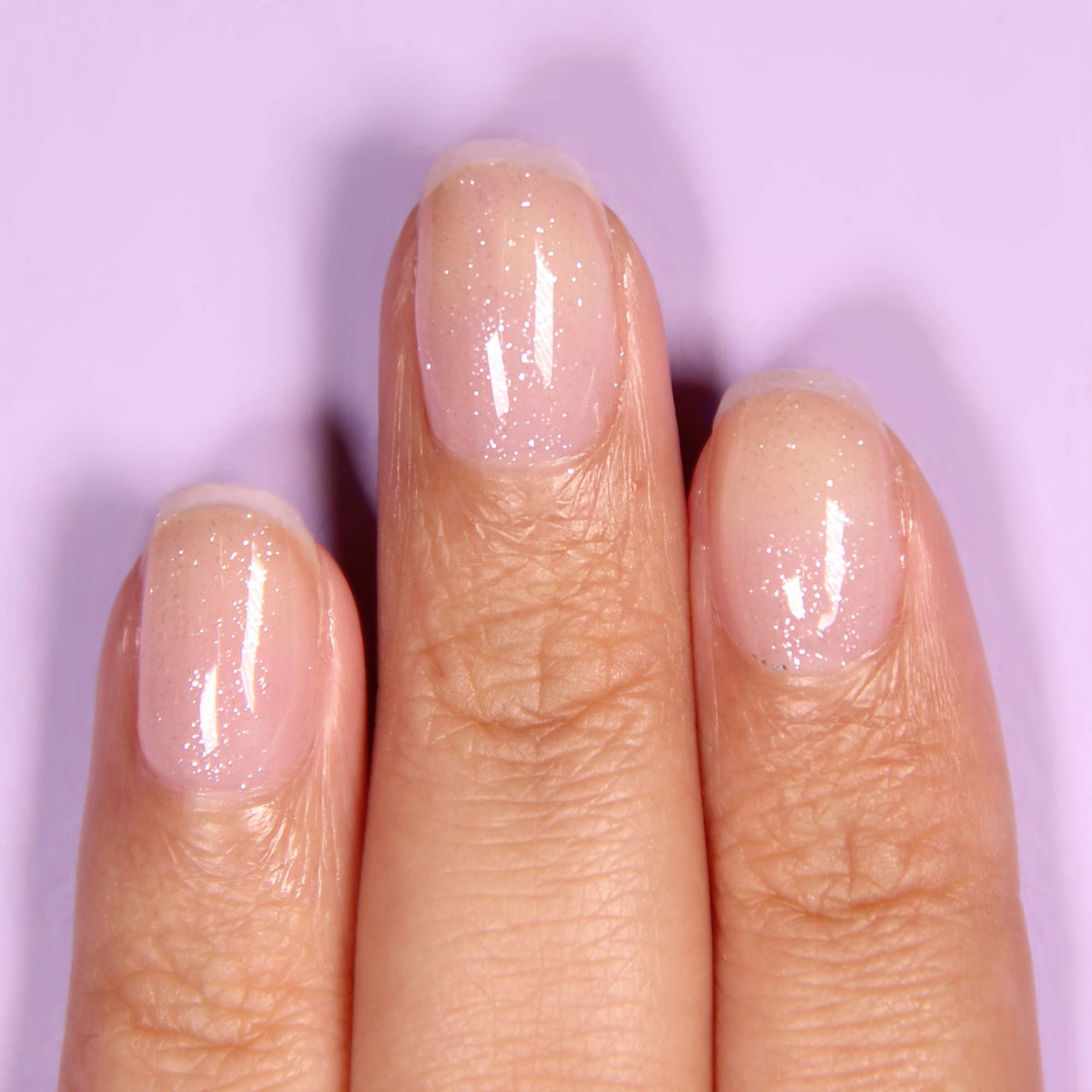 LONDONTOWN Diamond Shine Top Coat brush applicator applying a glossy coat to nails.