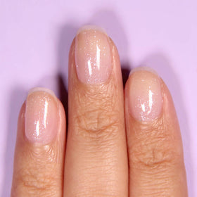 LONDONTOWN Diamond Shine Top Coat brush applicator applying a glossy coat to nails.