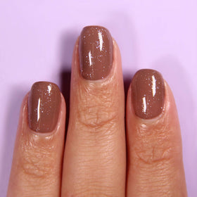 LONDONTOWN Diamond Shine Top Coat on nails adds dimension and high shine.