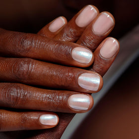 Layered chrome glaze on nails creating a futuristic, metallic depth.