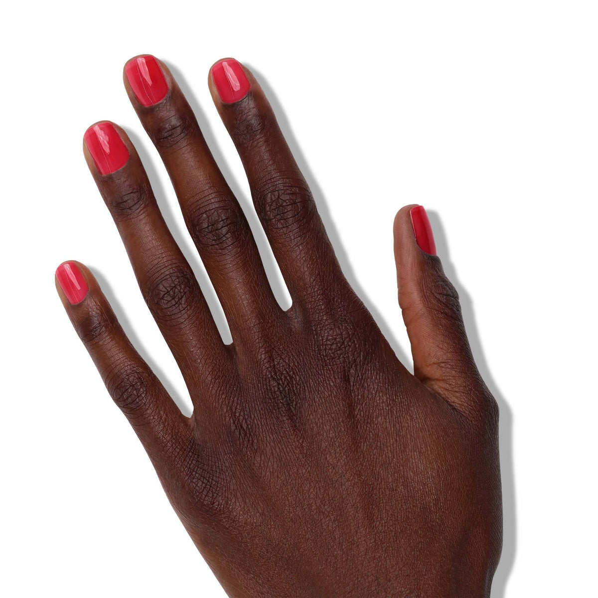 LONDONTOWN Nail Veil brush applying sheer poppy red for a natural look.