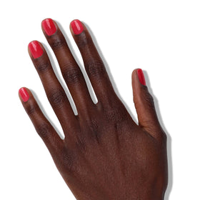 LONDONTOWN Nail Veil brush applying sheer poppy red for a natural look.