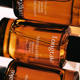 LONGTAKE Sandalwood Oil displayed on shelf with minimalist packaging.