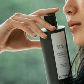 LONGTAKE Sandalwood Shampoo ingredients-camellia-oil close-up signals nourishing oils.