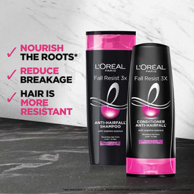 L'Oreal Paris Fall Repair 3X bottle close-up with creamy lather ready for scalp cleansing.