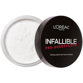 Brush applying Infallible Pro-Sweep and Lock powder for a smooth matte look