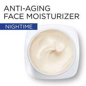 Revitalift night cream tub with applicator demonstrating easy nighttime use.