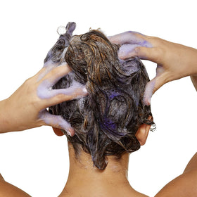 Packaging of L’Oréal Professionnel Paris Color Depositing Purple Conditioner on display