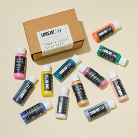 Close-up of vibrant Love is Art paints kit for skin-safe artistic expression.